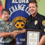 Aloha Exchange President Dale Tokuuke presents an 'Officer of the Month' award to Sergeant Jefferson Grantz