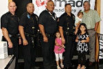 Officer Joshua Dumont, Officer Christopher Kapua-Allison, Officer James Waiamau, Erhard Autrata Jr. with his three children, Mayor Billy Kenoi 