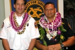 two men wearing leis