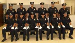 Recruits in uniforms, hats and gloves lined up in two rows.