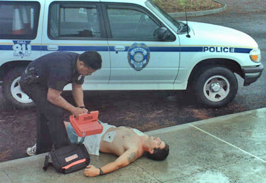 Photo of officer using defibrillator on victim