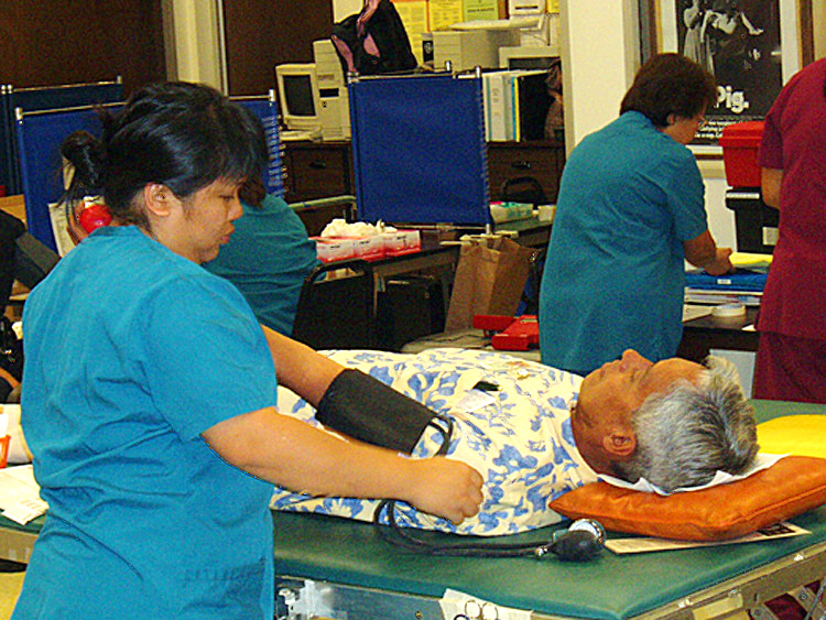 Photo of Assistant Chief Elroy Osorio donating pint of blood