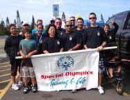 A group of participants stand with a banner reading "Special Olympics Training for Life"