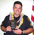 Image: Detective Freitas holding plaque