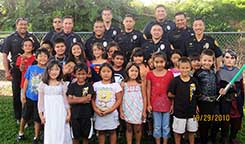 Image: large group of officers and kids.