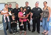 Image: five officers and two families