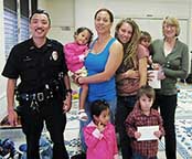 Image: two officers and two families.