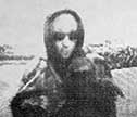 Surveillance photo of ATM suspect in hood and sunglasses
