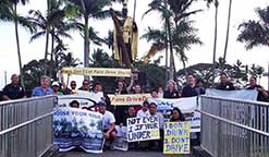 Image: group posing with signs